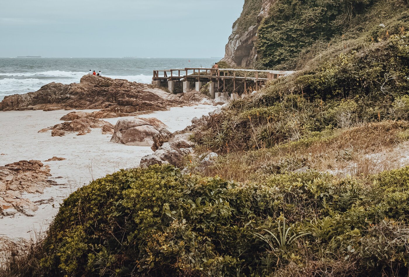 Passarela de madeira sobre as pedras de uma praia em Fernando de Noronha