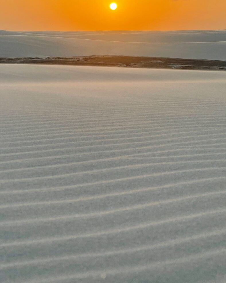 Pôr do sol sobre as ondulações de areia das dunas